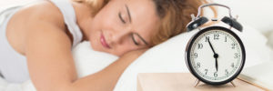 Beautiful happy woman sleeping in her bedroom in the morning. Well being and healthy sleeping concept. Letter box format